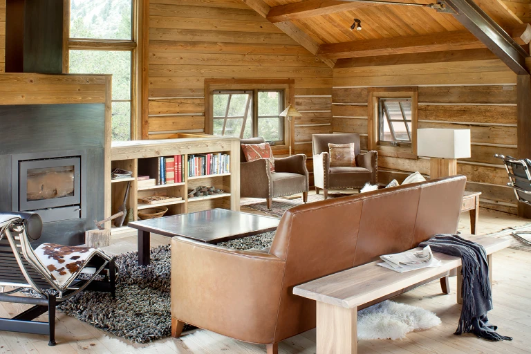 Secluded retreat with restored historic log structures and modern interiors by Chalk Creek